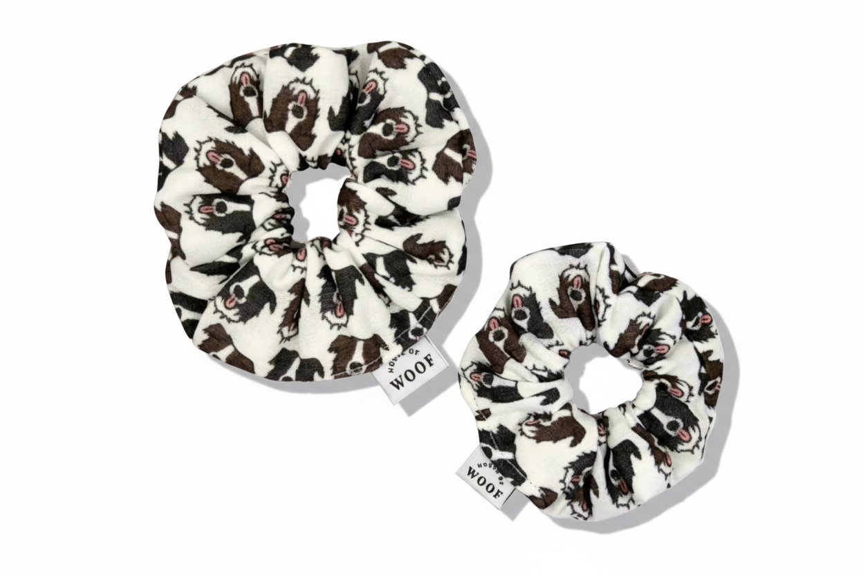 Two House of Woof fabric scrunchies featuring a Border Collie dog print, displayed on a warm beige background.