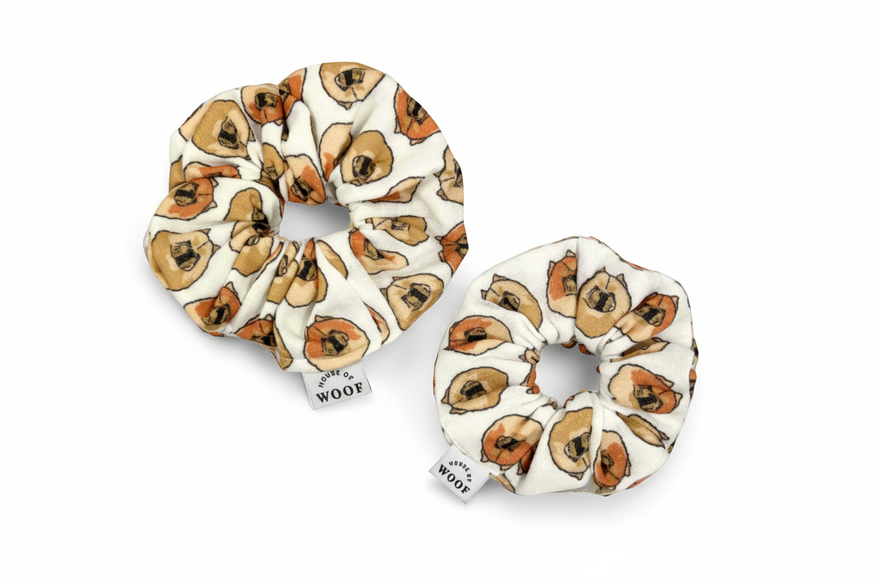 Two House of Woof fabric scrunchies featuring a Chow Chow dog print, displayed on a light grey background.
