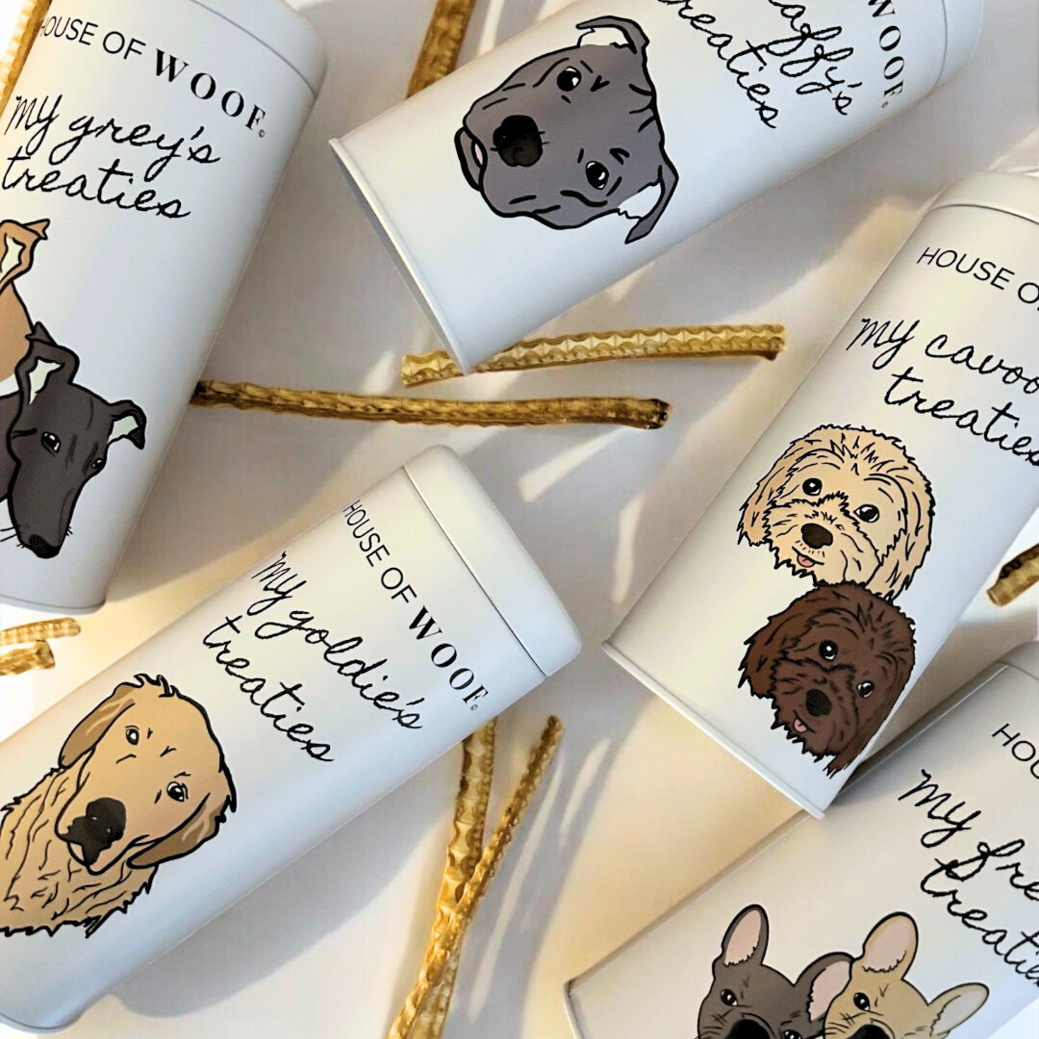 House of Woof breed dog treat tins — Greyhound, Cavoodle, Staffy, French Bulldog and Golden Retriever — white tins with hand-drawn dog faces.