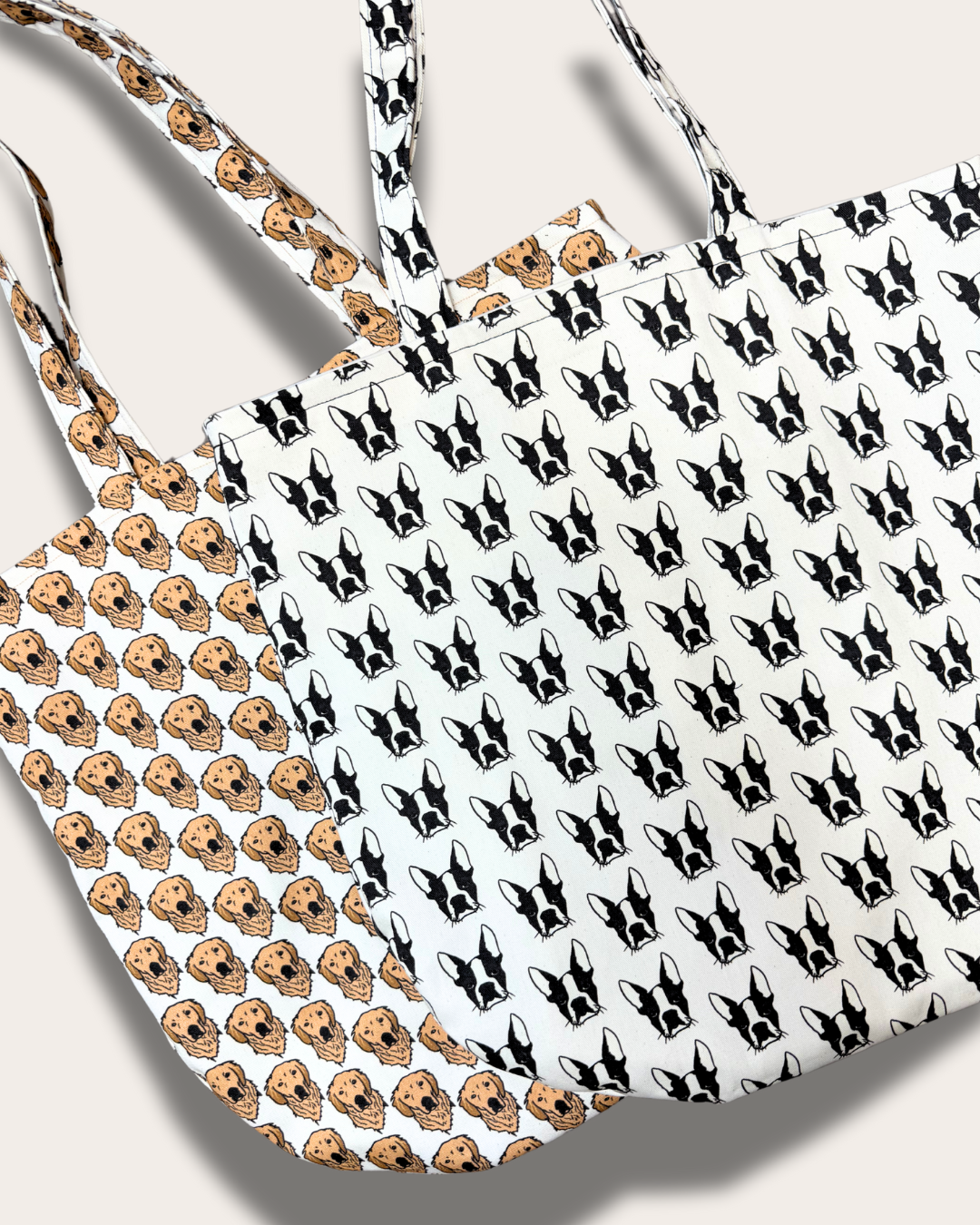 Two eco-friendly tote bags by House of Woof featuring hand-drawn Boston Terrier and Golden Retriever patterns, made from recycled and organic cotton.