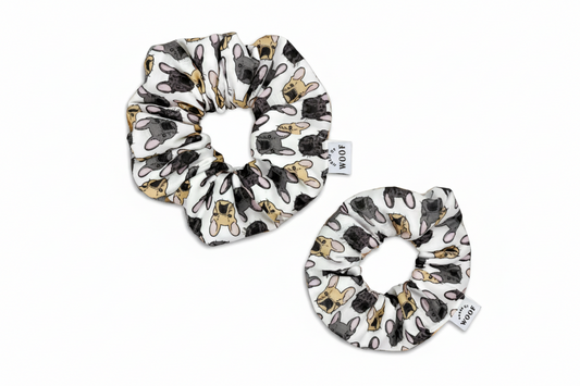 Set of two white fabric hair scrunchies featuring a hand-drawn French Bulldog pattern in fawn, grey, and black, by House of Woof.