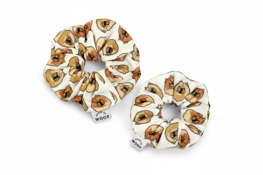 Two House of Woof fabric scrunchies featuring a Chow Chow dog print, displayed on a light grey background.