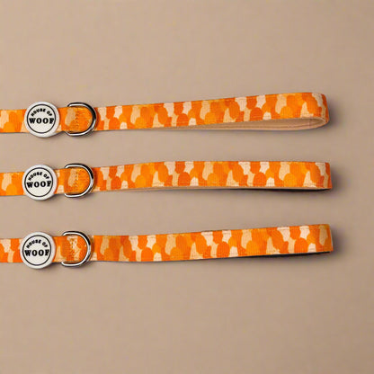 Orange and yellow patterned dog lead from House of Woof with metal clip and handle