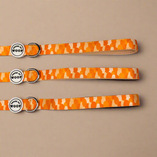 Orange and yellow patterned dog lead from House of Woof with metal clip and handle